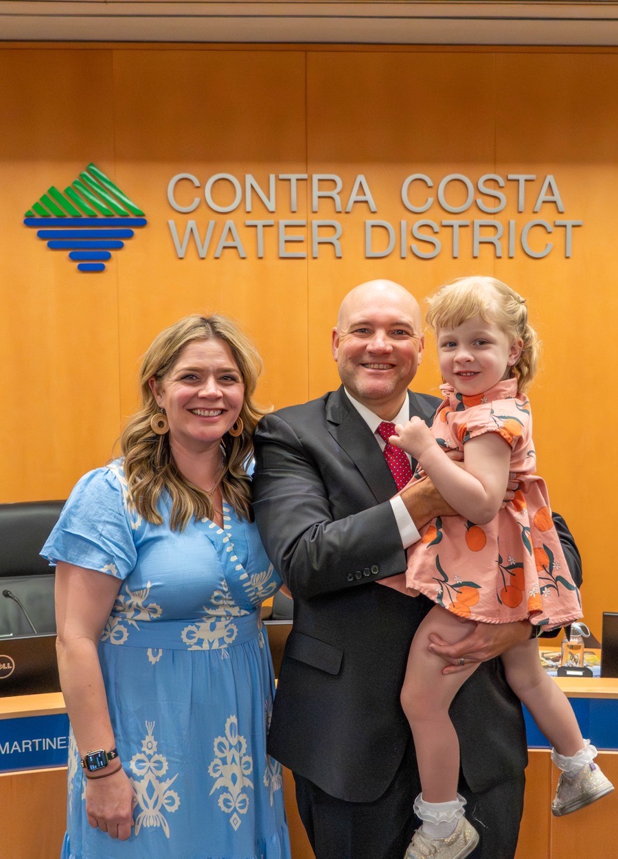 Dan Fitzpatrick with his wife Ashlee and daughter Sloane in the Contra Costa Water District board room.