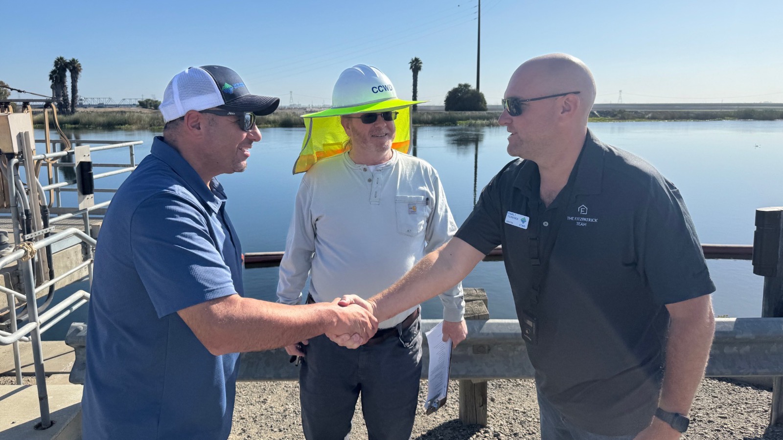 Dan Fitzpatrick shaking hands with a Contra Costa Water District operator at a Delta intake.